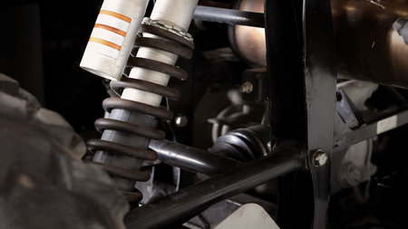 Old car suspensions. Close up car suspension wear and tear parts. CV joint Rubber boot and Control arms bushing Steering rack axles Shock absorber Brake exhaust. Gas Diesel car service repair parts.の写真素材