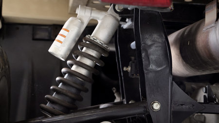 Old car suspensions. Close up car suspension wear and tear parts. CV joint Rubber boot and Control arms bushing Steering rack axles Shock absorber Brake exhaust. Gas Diesel car service repair parts.の写真素材