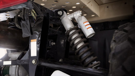 Old car suspensions. Close up car suspension wear and tear parts. CV joint Rubber boot and Control arms bushing Steering rack axles Shock absorber Brake exhaust. Gas Diesel car service repair parts.の写真素材