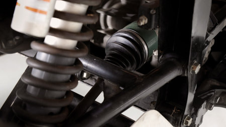 Old car suspensions. Close up car suspension wear and tear parts. CV joint Rubber boot and Control arms bushing Steering rack axles Shock absorber Brake exhaust. Gas Diesel car service repair parts.の写真素材