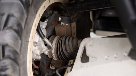 Old car suspensions. Close up car suspension wear and tear parts. CV joint Rubber boot and Control arms bushing Steering rack axles Shock absorber Brake exhaust. Gas Diesel car service repair parts.の写真素材