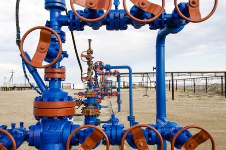 Group of wellheads. Oilfield with sand ground. Oil and gas concept.の写真素材