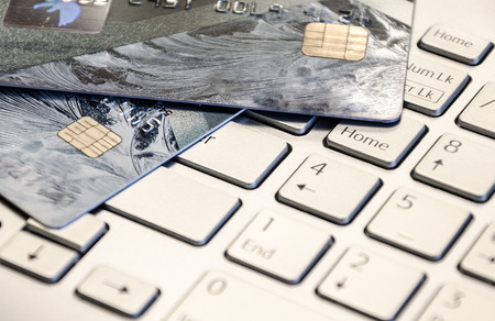 Credit cards on a laptop keyboard. On line shopping, e-commerce and internet purchase concept. Selective focus.の写真素材
