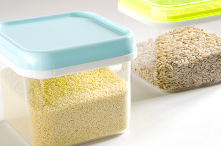 Food storage. Food ingredients (cous cous and wild rice) in plastic containers. Selective focus.の写真素材