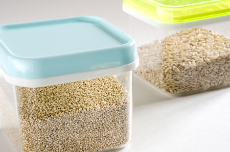 Food storage. Food ingredients (quinoa and wild rice) in plastic containers. Selective focus.の写真素材