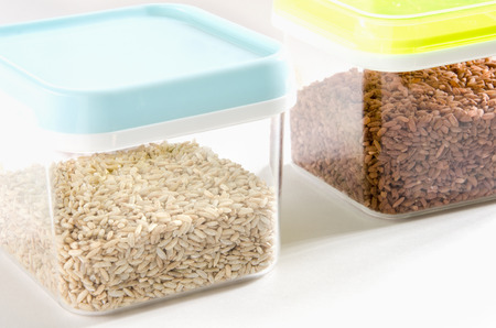 Food storage. Food ingredients (wild and brown rice) in plastic containers. Selective focus.の写真素材