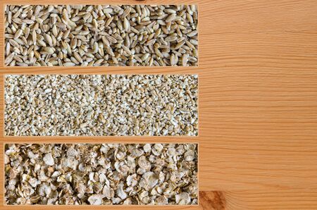 Collage consisting of spelt and cut wheat and wheat flakes. Food background. Healthy lifestyle concept. Closeup macro shot.の写真素材