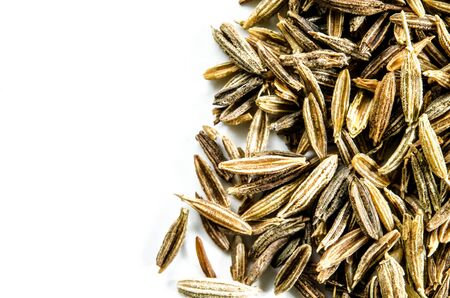 Dry cumin seeds isolated on white. Food background with copy space. Closeup macro shot. Top view.の写真素材