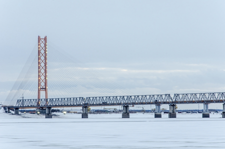 Cable-stayed bridge in winter evening with lights. The biggest bridge in the world with one pylon tower across Ob river in Siberia. の写真素材