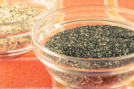 Oat flakes and chia seeds in a glass bowl on colorful dishcloth. Closeup shot. Healthy food concept. Toned.の写真素材