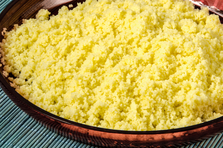 Plate with freshly cooked Moroccan couscous on blue straw backgroundの写真素材