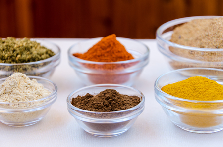 Different kind of colorful spices powder in glass bowls. Food and cuisine additives.の写真素材