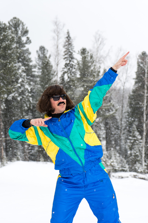 Vintage photo of young man snowboarder in the mountains. Retro style. 1980 concept.の写真素材