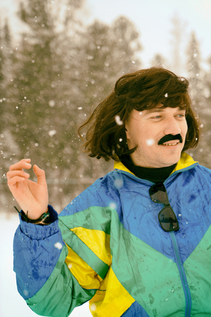 Vintage photo of young man snowboarder in the mountains. Retro style. 1980 concept.の写真素材