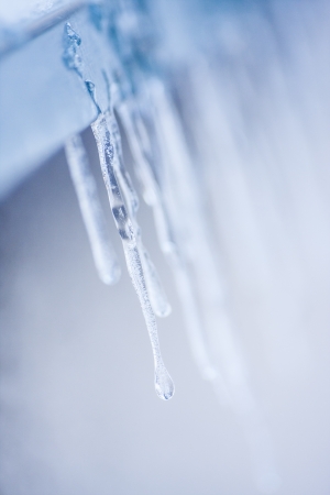 Number of icicles emerged on window ledge during cold winterの写真素材