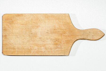 Old used kitchen wooden cutting board with scratch marksの写真素材