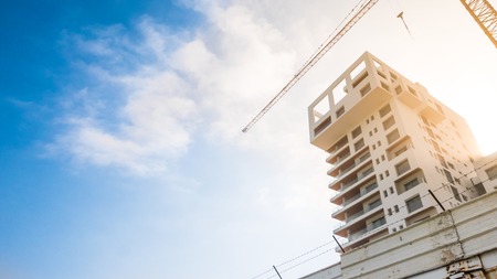 One building reaching to the sky being developed and finished upの写真素材