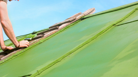 Caucasian man on the Ladder painting waterproof protective layerの写真素材