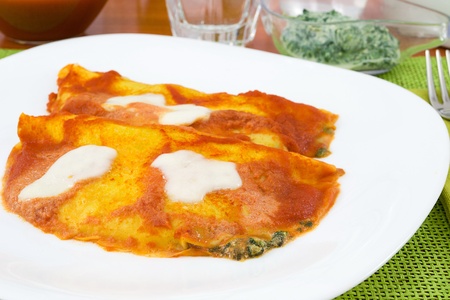 mozzella crepes with spinach and tomato sauceの写真素材