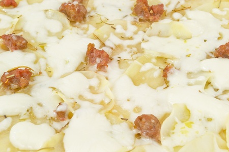 pizza with potatoes and sausageの写真素材