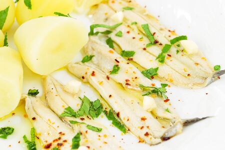 appetizer of anchovies and boiled potatoesの写真素材