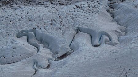 Water Stream Cutting Through Snowの写真素材