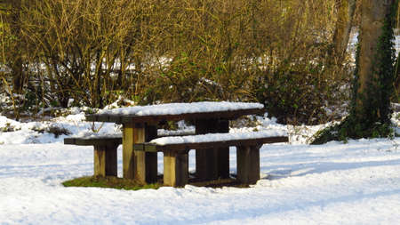 Snow Covered Picnic Table and Benches During Winterの写真素材