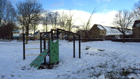 Children's Playground Covered in Snow During Winterの写真素材