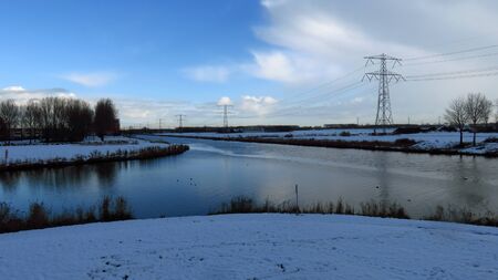 Dutch Winter Landscape with Canal Intersection Covered in Snowの写真素材