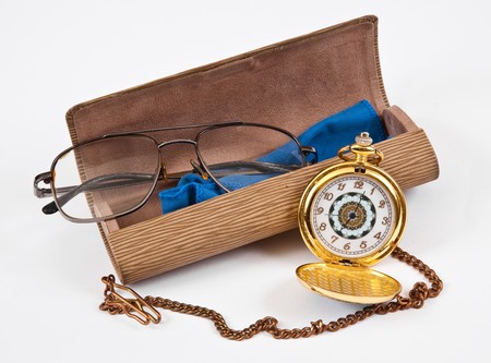 Glasses, eyeglass case and the clockの写真素材