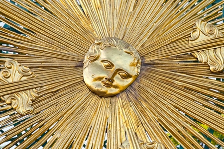 Gilded image of a sun