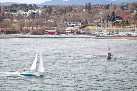 Seascape. Boat floating along with the shoreの写真素材