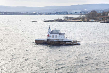 Modern comfortable house on a large stone in the middle of the fjordのeditorial素材