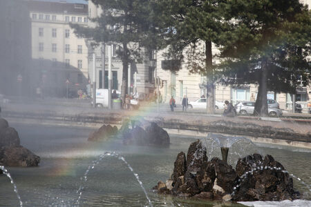 Multi-colored rainbow in the fountain water spray jetsの写真素材