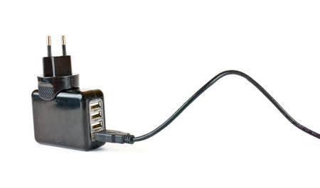 An universal charge device for domestic electronics on four ports is isolated on a white backgroundの写真素材