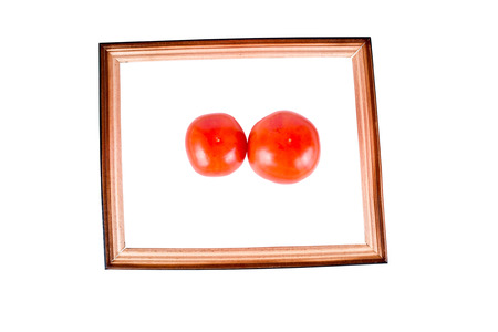 Tomato in a frame isolated on white backgroundの写真素材