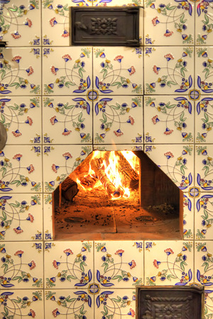 RUSSIA, ROSTOV - January 03.2015: Beautiful home Dutch stove with burning firewoodの写真素材