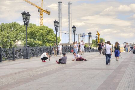 MOSCOW, RUSSIA - July 22.2015: People are photographed sitting in the Patriarshy, Bridgeのeditorial素材