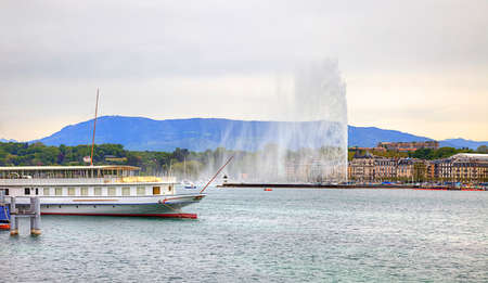 SWITZERLAND, GENEVA - May 06.2014: Excursion cutter and high fountain on the Genevan lakeのeditorial素材