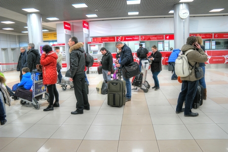 SHEREMETYEVO, RUSSIA - March 18.2016: Passengers wait a train near the cashdesks of aeroexpress in an airportのeditorial素材