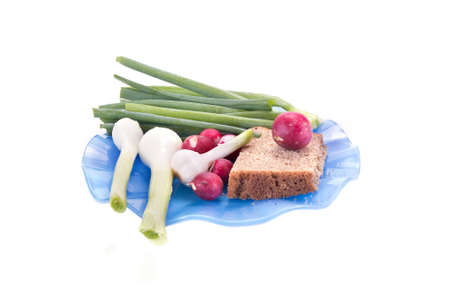 Slice of rye bread and green goods on a blue saucerの写真素材