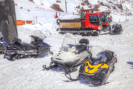 CAUCASUS, RUSSIA - May 01.2015: Snow grooming and snowmobiles next to the station of ropeway on the slope of mountain Elbrusのeditorial素材