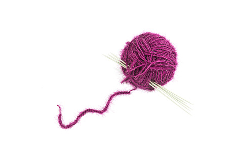 The ball of woolen threads with spokes is isolated on a white backgroundの写真素材