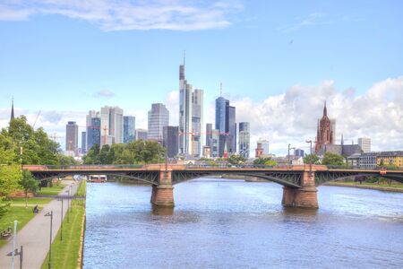 FRANKFURT AM MAIN, GERMANY - May 07.2014: City landscape. Main river embankment and bridgeのeditorial素材