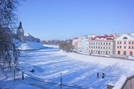 PSKOV, RUSSIA-February 21.2010: Pskova River. Tower of the Pskov fortress and the beautiful facades of modern houses on Sovetskaya embankmentのeditorial素材