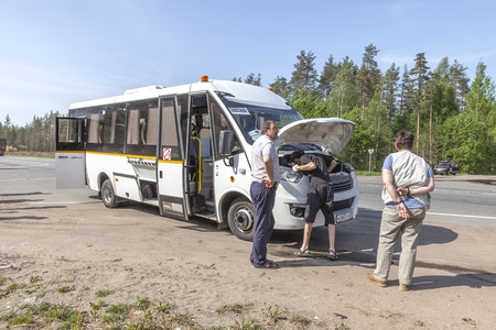 VIBORG, RUSSIA - June 05.2019: A tourist bus driver fixes a problem in the engineのeditorial素材
