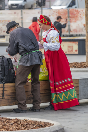 MOSCOW, RUSSIA - October 03.2019: The territory of the modern Zaryadye park in the historical part of the city. Artists in Russian national clothes are preparing for a performanceのeditorial素材