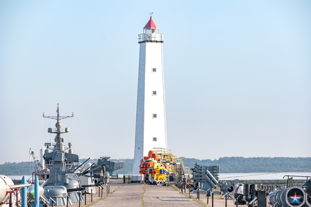 RUSSIA, KRONSHTADT - June 05.2019: Merchant's harbor. Antique wooden lighthouse and exposition of military equipmentのeditorial素材