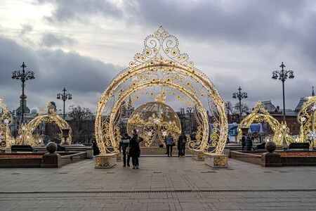 RUSSIA, MOSCOW - December 30.2019: Glowing arches and a huge ball on Theatre Square on New Year's Eve. Journey to Christmas, light laceのeditorial素材