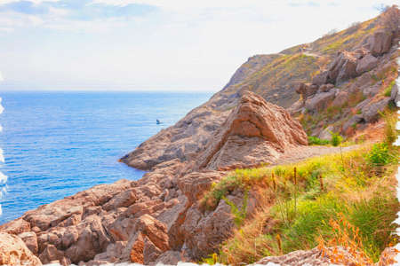 Oil paint on canvas. Picture with photo, imitation of painting. Illustration. Golitsyna Trail. A narrow walking trail along the seashore along Mount Koba-Kaya. Crimea. Settlement Novyy Svetのeditorial素材
